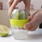 Presse-citron manuel en plastique et verre – design compact avec réservoir intégré